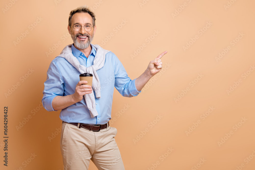 Cheerful senior businessman enjoying coffee and showcasing happiness with trendy casual attire on beige background Cheerful senior businessman enjoying coffee and showcasing happiness with trendy casual attire on beige background