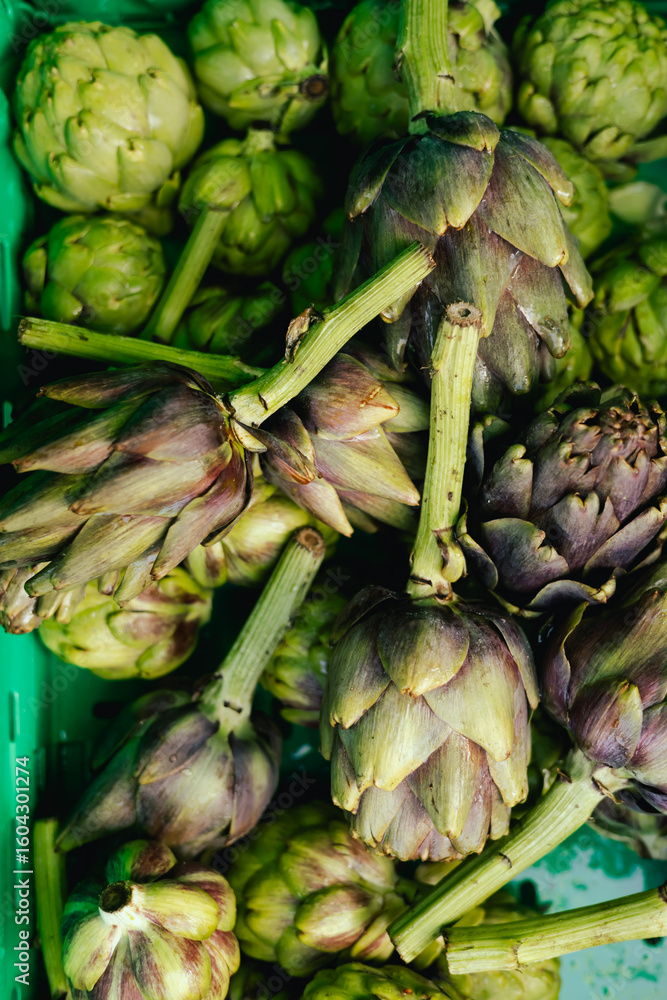 Obraz premium Fresh greens at small local urban market. Organic produce on sale at outdoor farmer market. Selling fresh crops and veggies harvest. European urban setting. Close up. Part of the series.