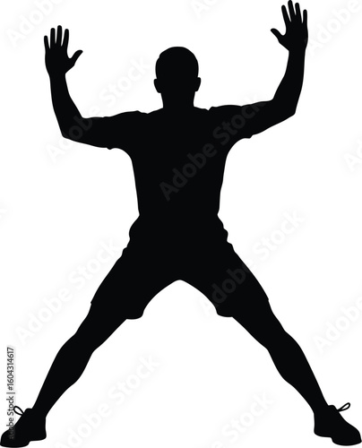 Silhouette of a man doing jumping jacks for fitness