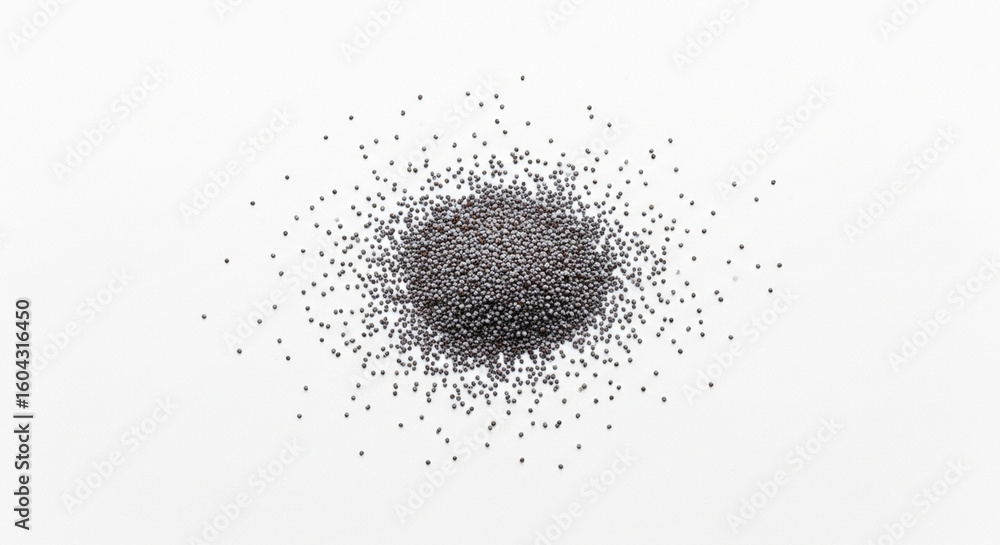 Obraz premium A pile of tiny dark roughly spherical seeds scattered on a clean bright white surface