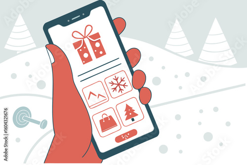 A hand holding a smartphone displaying a winter holiday app with icons for gifts snowflakes shopping and a christmas tree against a snowy landscape