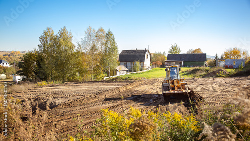 Wallpaper Mural Yellow bulldozer at a construction site. Big wheel excavator leveling and clearing the land plot side view. Moving earthworks soil. Copy space. Building area. Special transport. High quality photo. Torontodigital.ca