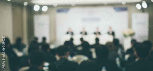 Wallpaper Mural Blurred image of a conference audience with speakers on stage in a room. Torontodigital.ca
