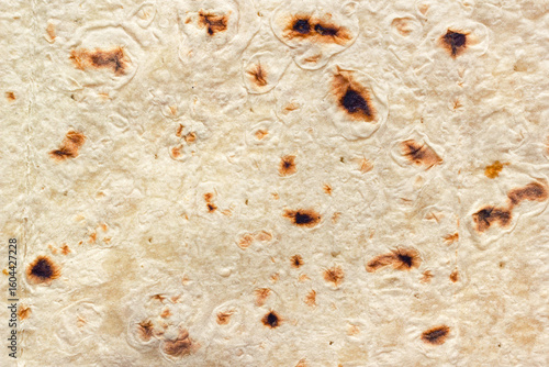Traditional armenian lavash flatbread. The detailed closeup texture for background or causcasian cuisine cooking recipes.