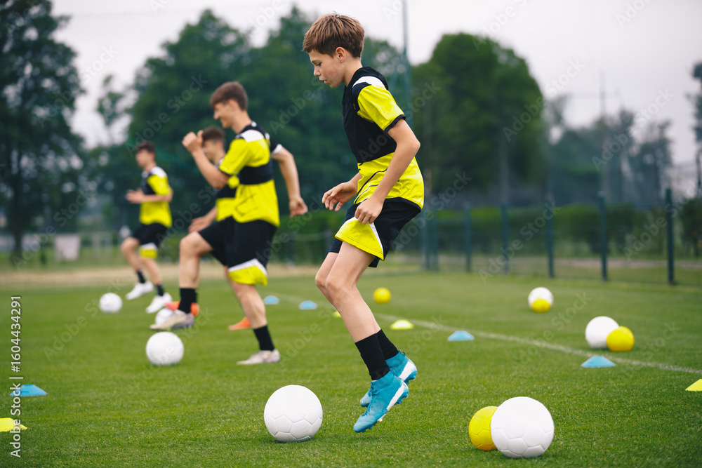 Youth Soccer Training on Grass Field. Boys Practicing Football Drills with Cones and Balls. Football Academy Practice Session Youth Soccer Training on Grass Field. Boys Practicing Football Drills with Cones and Balls. Football Academy Practice Session