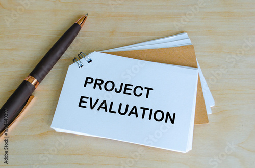 Slika na platnu Project Evaluation text on white notepad