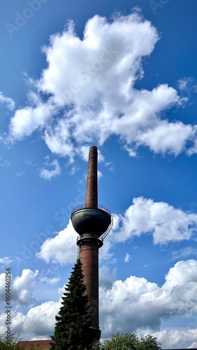 industrial chimney with blue sky and clouds, lengerich, germany