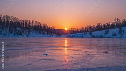 Fototapeta Naklejka Na Ścianę i Meble -  Twilight scene of a lake surrounded by winter scenery