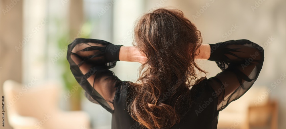 Fototapeta premium The woman enjoying a moment of relaxation in a cozy indoor setting.