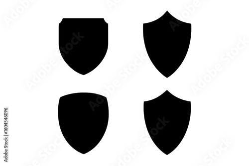 Set of 4 flat silhouette icons of protective shields. Knightly military shield insignia of different shapes. Vector elements for logo, emblem, crest, or security symbol.