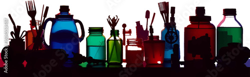 An artistic ensemble of bottles and jars filled with vibrant liquids and art supplies showcasing a creative studio setup