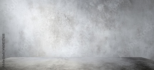 The textured gray concrete wall providing a minimalist backdrop for creative displays.