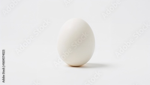 Close-up of an unbroken egg with a white background