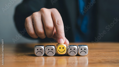 Choosing positivity person selects happy face cube amidst sad faces demonstrating customer satisfaction and positive feedback selection