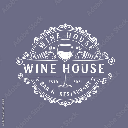 Vintage wine house logo with ornate floral design, wine glass icon, bar restaurant emblem.