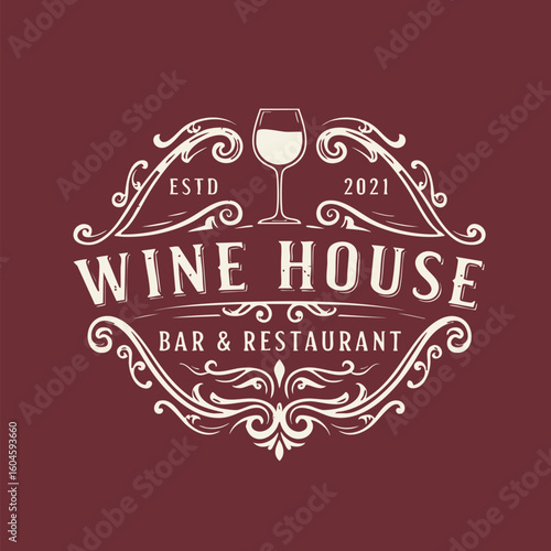 Vintage wine house logo with ornate floral design, wine glass icon, bar restaurant emblem.