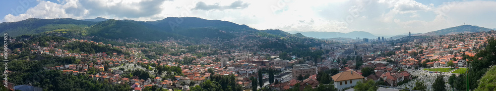 Naklejka premium Panoramic Skyline of Sarajevo with Kovači Cemetery and Mountain Backdrop
