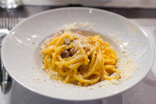 Photography Carbonara with guanciale, pecorino cheese and egg made according to the traditio