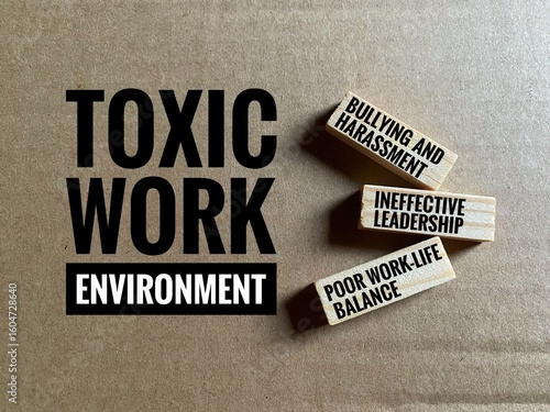Conceptual photo depicting a toxic work environment, with wooden blocks listing common issues like bullying, harassment, ineffective leadership, and poor work-life balance.