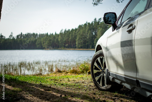 Fototapeta Naklejka Na Ścianę i Meble -  A white car near the lake