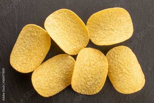 Crispy potato chips, top view, macro.