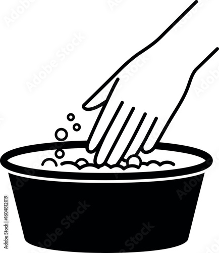 Hand washing clothes in basin