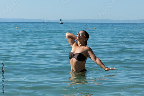 Sunglasses-wearing tourist floating leisurely in turquoise waters of sea of cortez, baja california sur, mexico