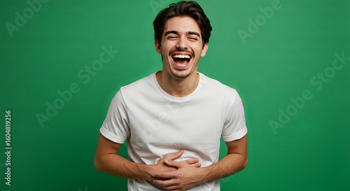 Laughing man against solid green background