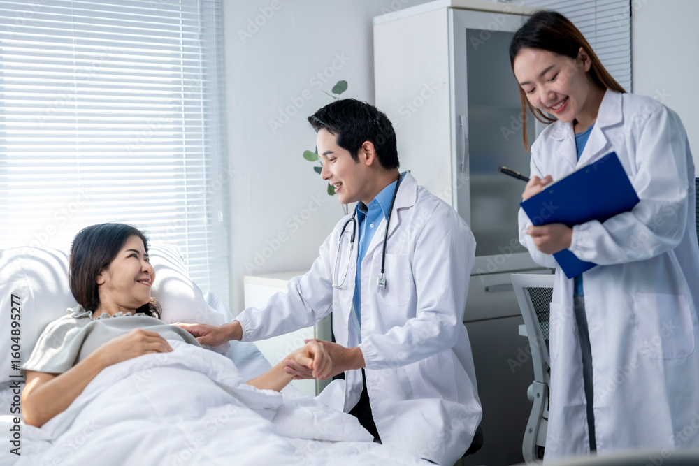 A woman is laying in a hospital bed with a doctor and nurse standing next to her A woman is laying in a hospital bed with a doctor and nurse standing next to her