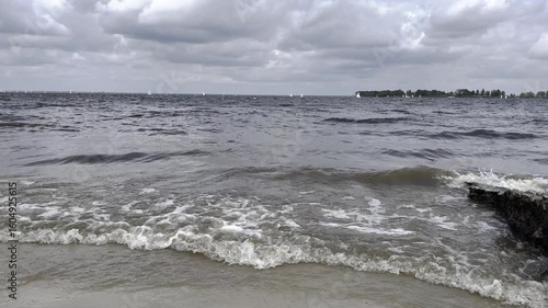 Sailing competition in the Dnipro river in cloudy and stormy weather, horizontal video	