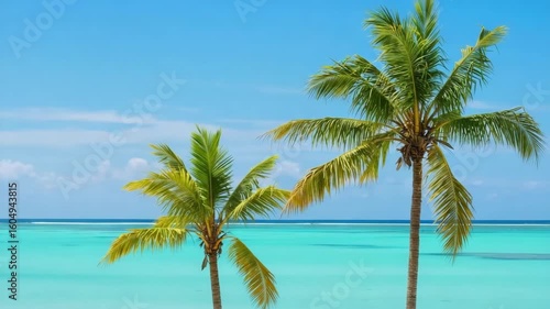 Wallpaper Mural Pair of palm trees swaying against a bright blue tropical ocean backdrop Torontodigital.ca