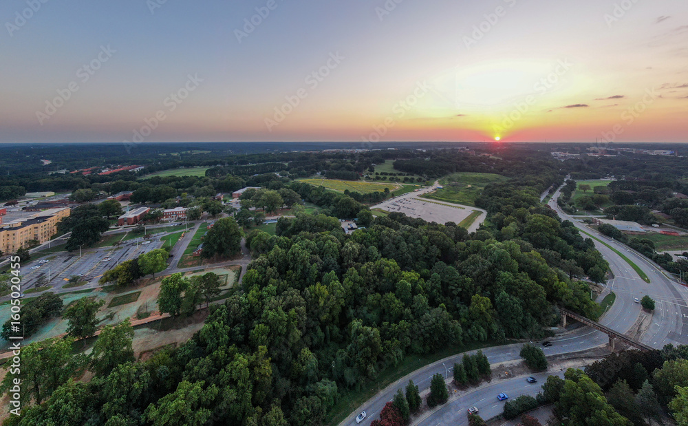 Fototapeta premium Various Sunset Drone Images of Downtown Raleigh NC Featuring the Skyline, Dix Park, and Central Prison.