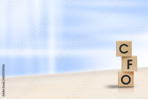 CFO Concept Blocks on Desk with Blue Background