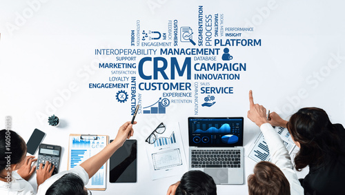 Photos A dynamic business team collaborates on customer relationship management strategies, analyzing data visualization tools to drive innovation and improve performance in a corporate setting