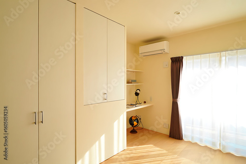 Sunlight Streamed Across a Minimalist Bedroom Featuring a Built-in Desk and Wall-Mounted Air Conditioner