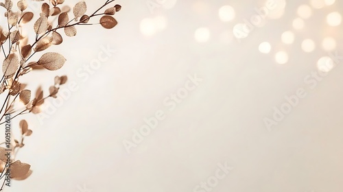 Gold leaves, bokeh lights on pale background