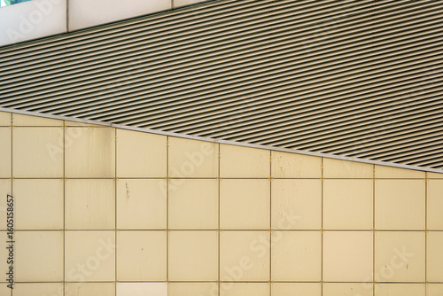 Bilde på lerret A modern building with a contrasting composition of diagonal lines and square panels showcases architectural rigor and graphic appeal