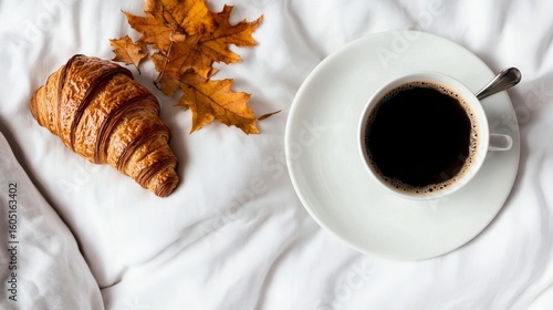 Enjoying Coffee and Croissant With Autumn Leaves on a Cozy Bed During a Peace...