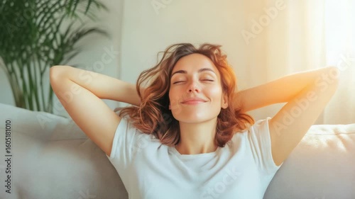 Young woman enjoys a moment of peace and relaxation on her comfortable sofa, relieving stress and practicing effective time management by taking a break