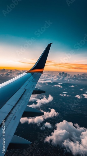 Beautiful Sunset View From an Airplane Wing Over Fluffy Clouds During a Journey
