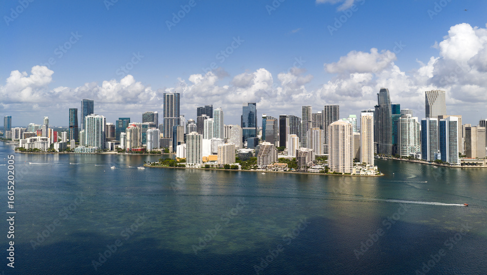 Fototapeta premium Aerial panorama of Brickell in Miami. Downtown Miami skyline on a sunny day. Scenic view of Miami Beach and Brickell. Miamis Skyscrapers. Brickell famous landmarks. Miami downtown landscape.