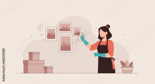 Woman Cleaning Dust From Wall Display Frames, Home Hygiene Maintenance