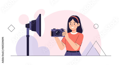 Young Woman With Camera Taking Pictures In Professional Studio Setup
