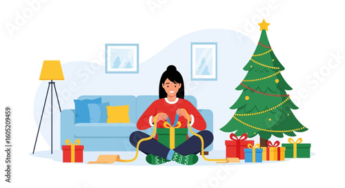 Woman Sitting On Floor Unwrapping Christmas Present Near Decorated Tree