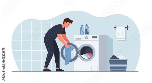 Young Man Doing Laundry At Home Putting Clothes In Washing Machine