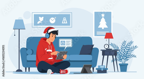Young Man Relaxing At Home With Tablet And Laptop During Winter Holiday