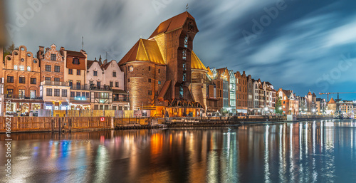 Gdańsk waterfront at night with Żuraw Crane and cloudy sky