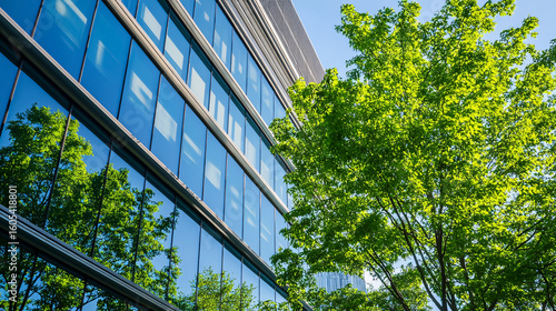 A modern office building is framed by lush green trees, symbolizing business success.