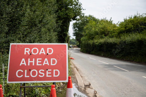 Canvas Print Photo of a red Road Ahead Closed sign placed at the roadside