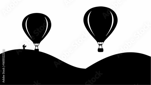 Two black hot air balloons floating above a silhouette of rolling hills with a small figure standing there